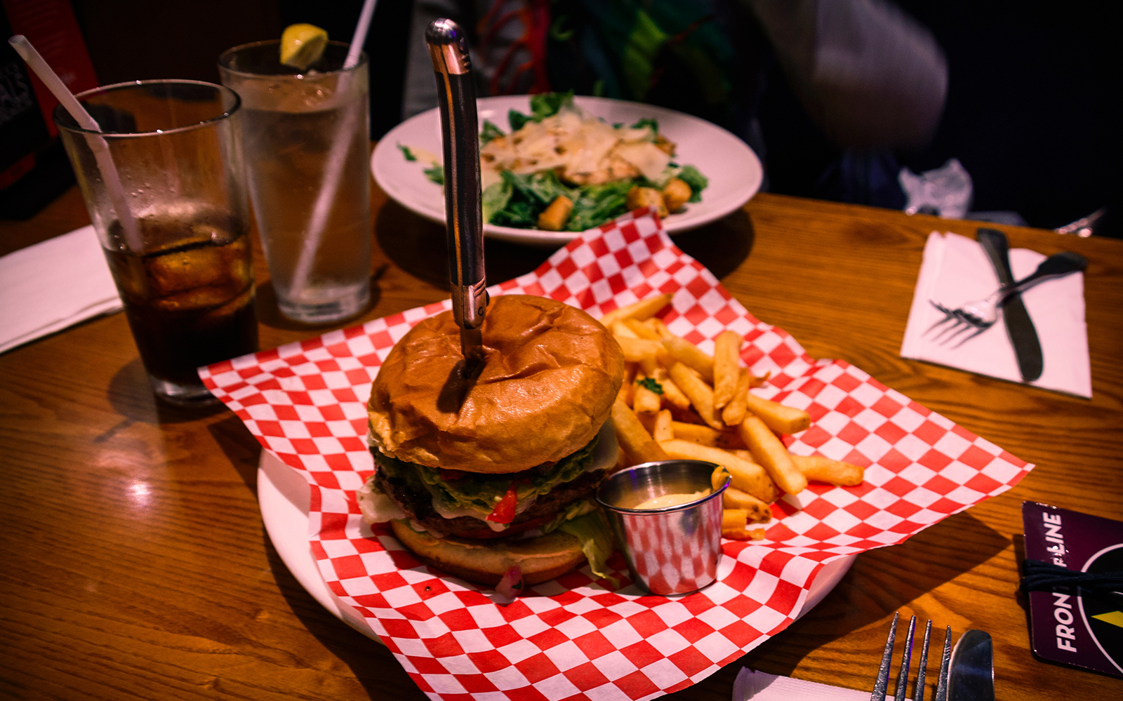 Burger and fries at Hard Rock Cafe with drinks and salad.