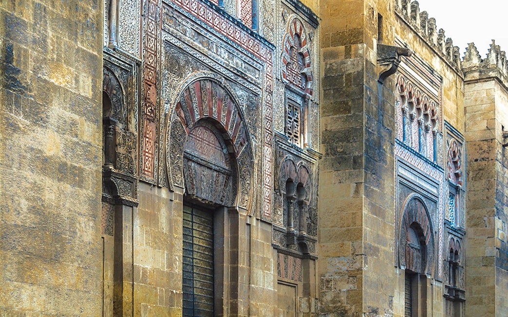 Exterior of the Great Mosque of Cordoba with intricate arches and stonework.