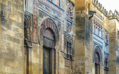 Exterior of the Great Mosque of Cordoba with intricate arches and stonework.