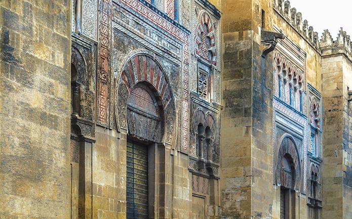 Exterior of the Great Mosque of Cordoba with intricate arches and stonework.