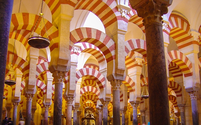 Striped arches inside the Mosque-Cathedral of Córdoba on a day trip from Granada.