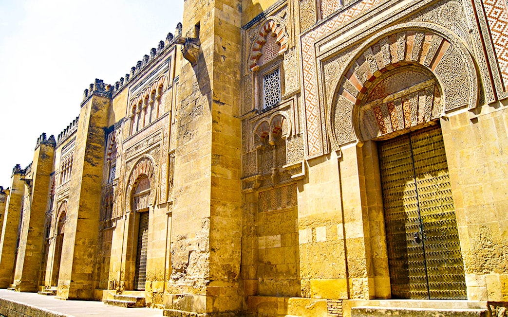 Exterior of the Great Mosque of Cordoba with intricate arches, seen on a day trip from Granada.