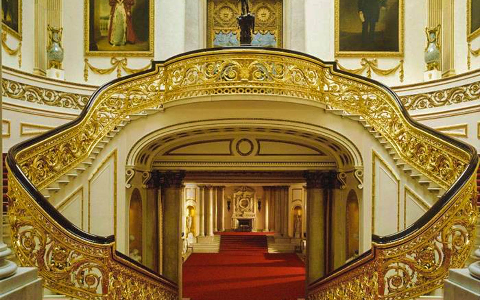 Buckingham Palace grand staircase with ornate gold detailing, London.