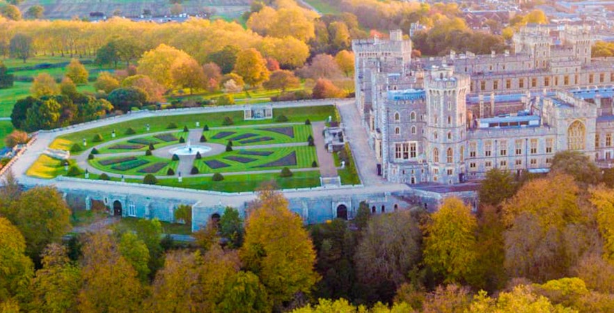 Aerial view of Windsor Castle gardens and surrounding landscape.