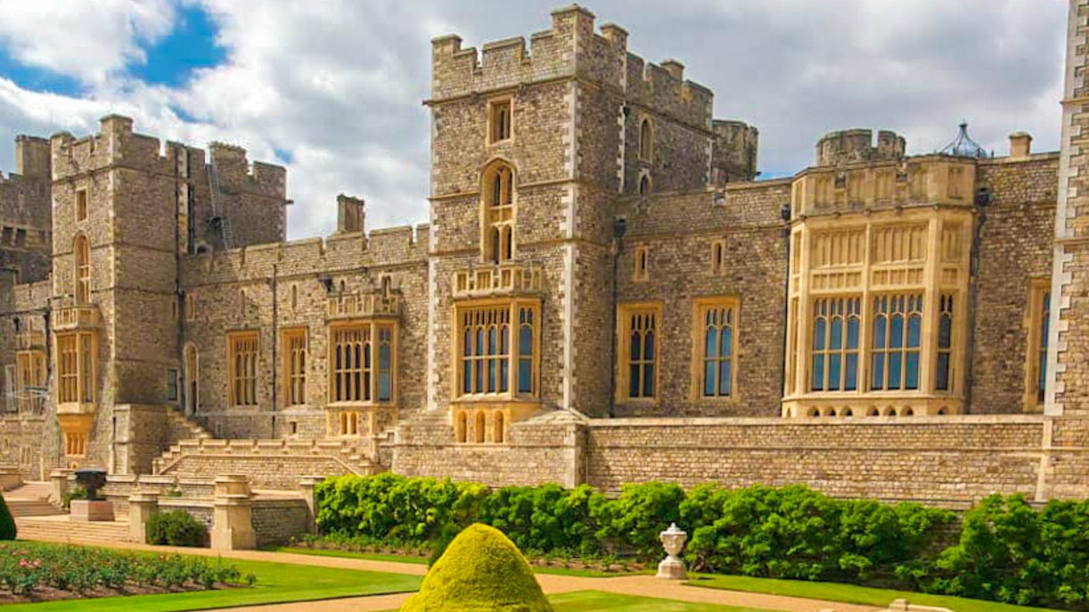 Windsor Castle exterior with manicured gardens, part of Buckingham Palace & Windsor Castle tour.