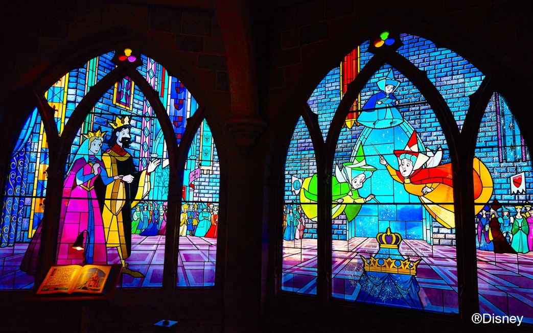 Stained glass windows depicting Sleeping Beauty scenes at Disneyland Paris.
