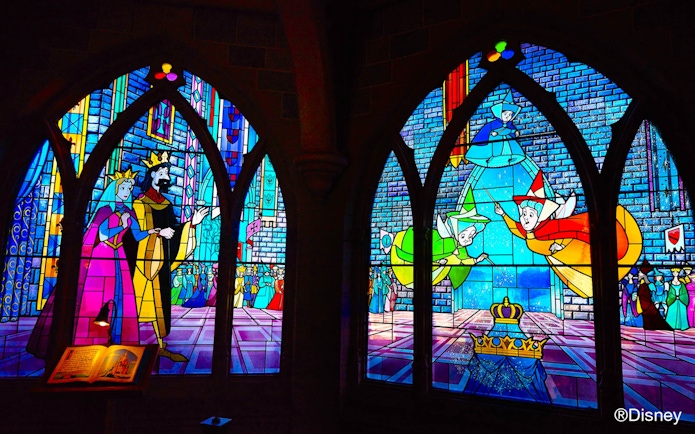 Stained glass windows depicting Sleeping Beauty scenes at Disneyland Paris.