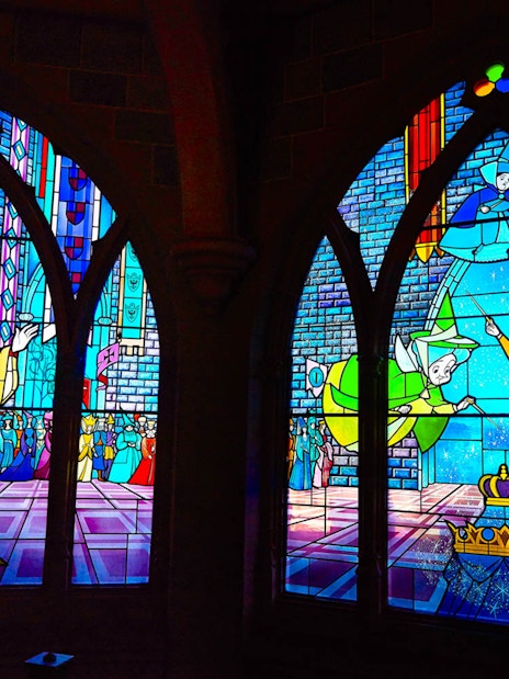 Stained glass windows depicting Sleeping Beauty scenes at Disneyland Paris.