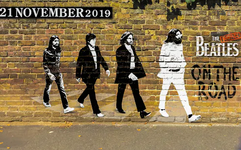 The Bootleg Beatles mural on a brick wall with "On The Road" text.