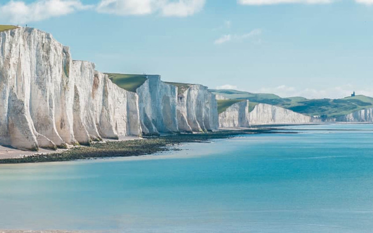White Cliffs of Dover along the coastline under a clear sky.