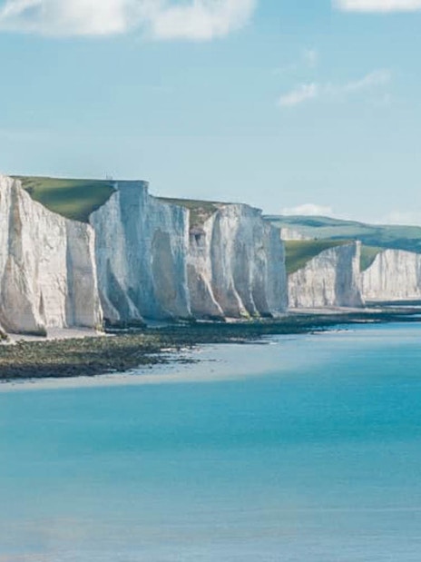 White Cliffs of Dover along the coastline under a clear sky.