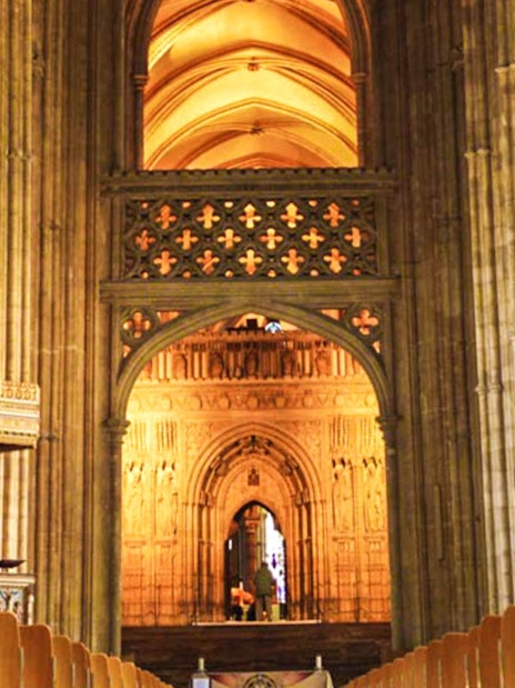 Interior view of Canterbury Cathedral's nave with ornate arches and columns.