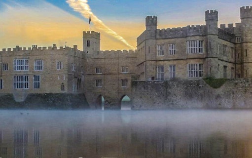 Leeds Castle with mist over the moat at sunrise, part of the Leeds Castle, Canterbury Cathedral & White Cliffs of Dover Tour.