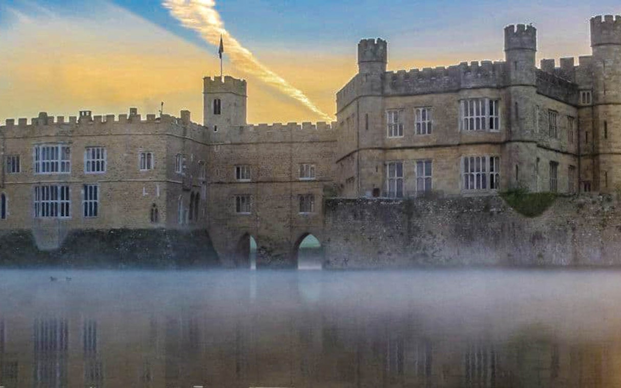 Leeds Castle with mist over the moat at sunrise, part of the Leeds Castle, Canterbury Cathedral & White Cliffs of Dover Tour.