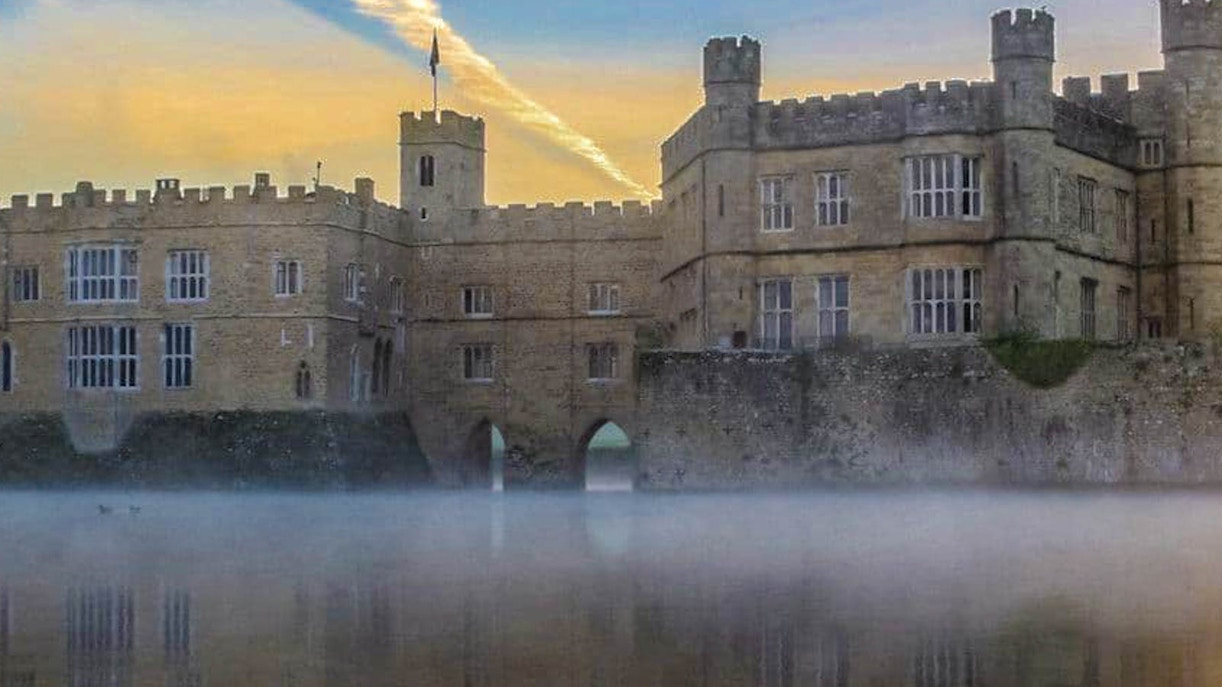 Leeds Castle with mist over the moat at sunrise, part of the Leeds Castle, Canterbury Cathedral & White Cliffs of Dover Tour.