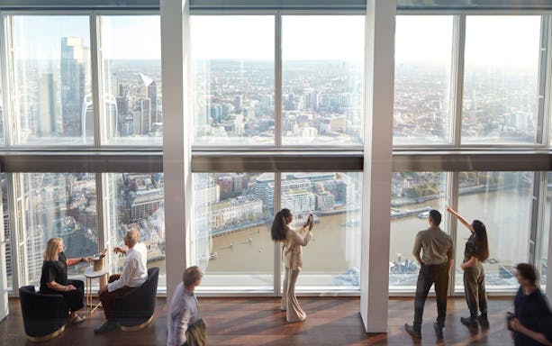 Visitors enjoying panoramic views of London from The Shard's observation deck.