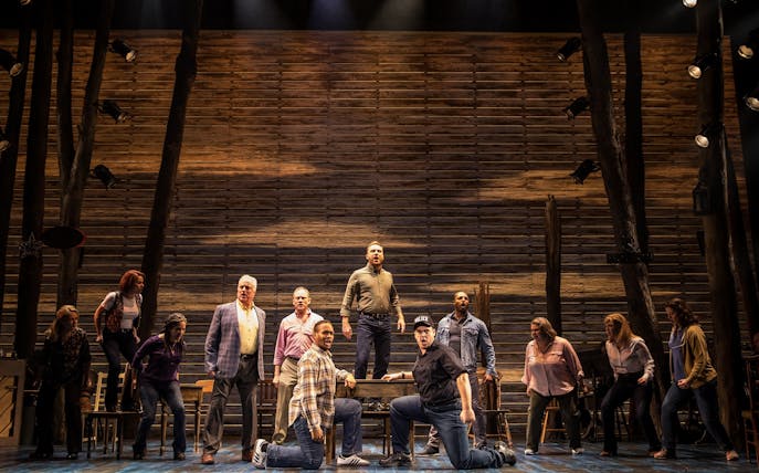 Cast performing "Come From Away" on stage, featuring a wooden backdrop, part of a dinner and show experience at Belgo Centraal.