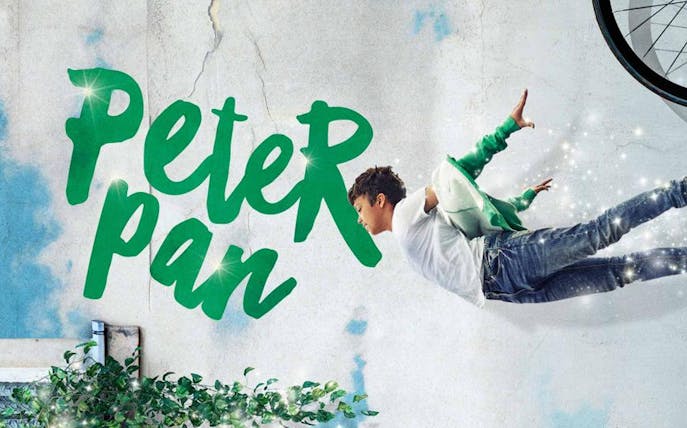 Peter Pan character flying with sparkles against a textured wall background.