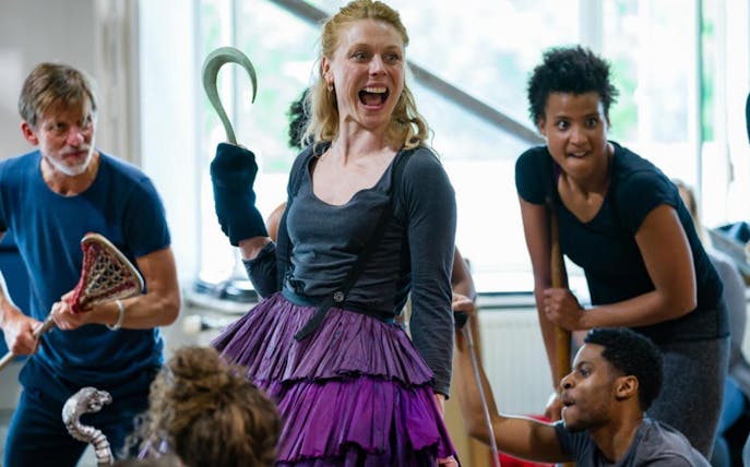 Actors rehearsing a scene from Peter Pan, one holding a hook, in a lively studio setting.