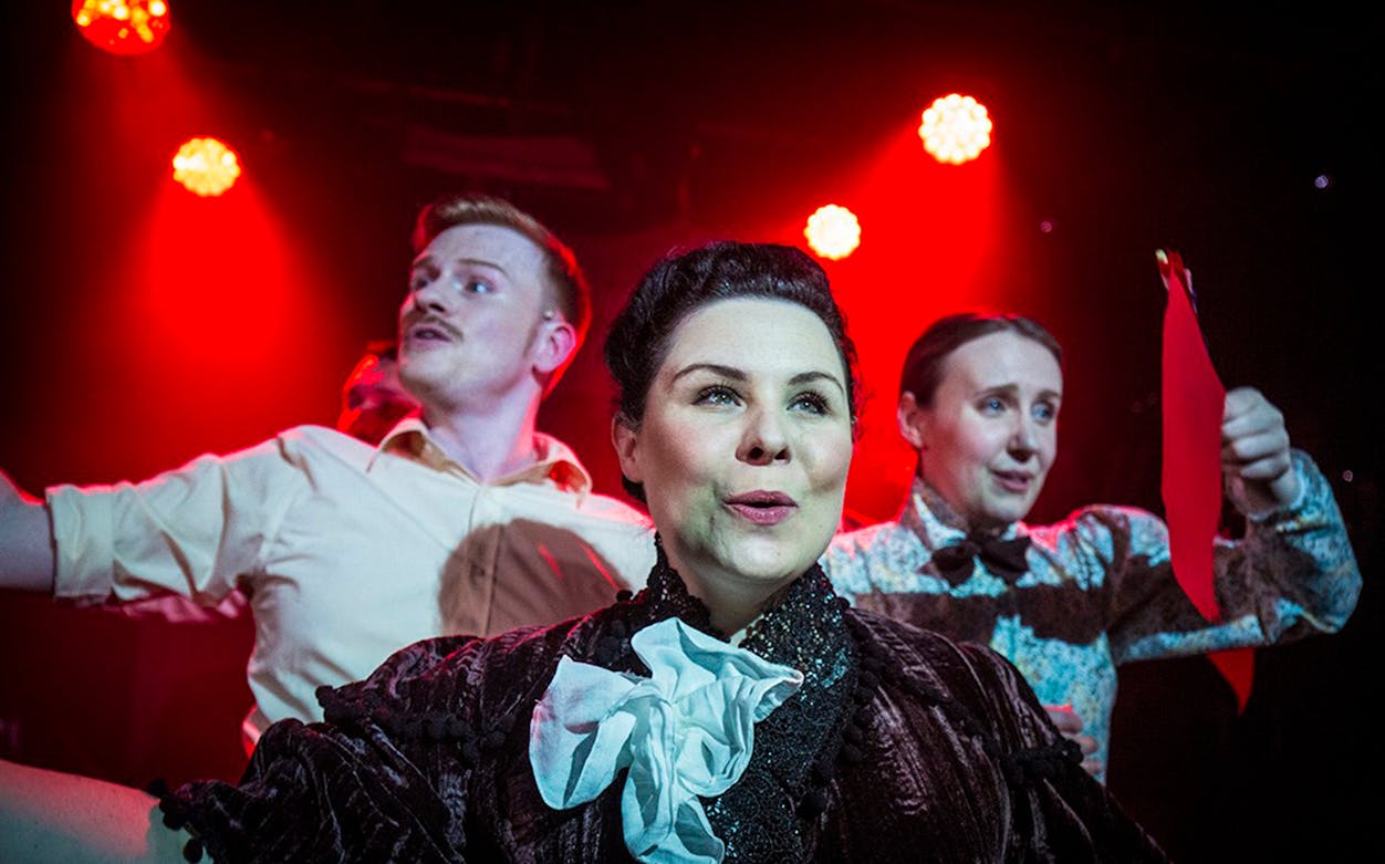 Performers on stage in "Queen Of The Mist" musical scene.