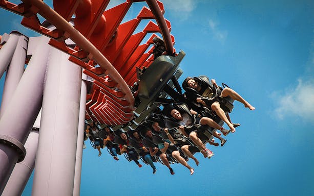 Roller coaster ride at Siam Park City, Bangkok, with people enjoying the thrill.