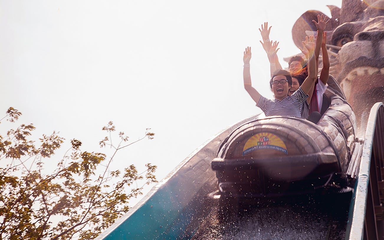 Visitors enjoying a log flume ride at Siam Park City, Bangkok.