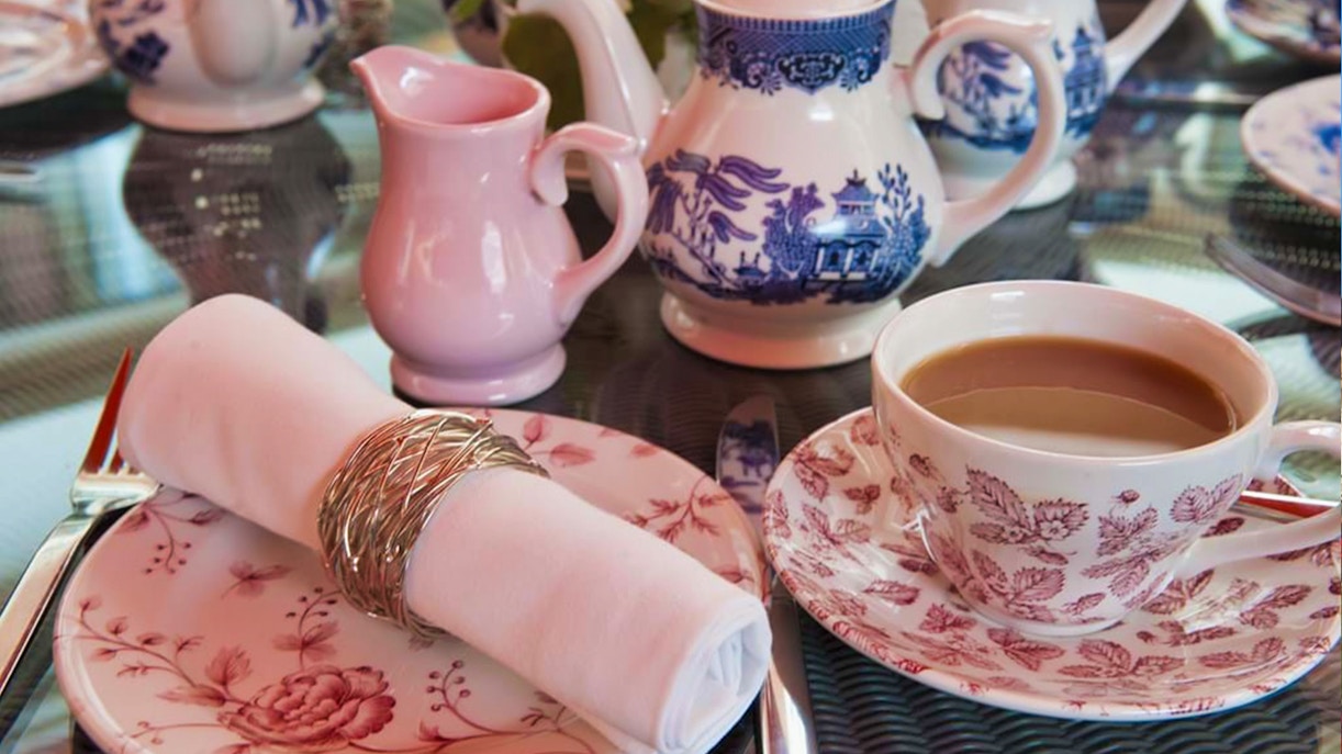 Afternoon tea set with floral china at Buckingham Palace State Rooms.