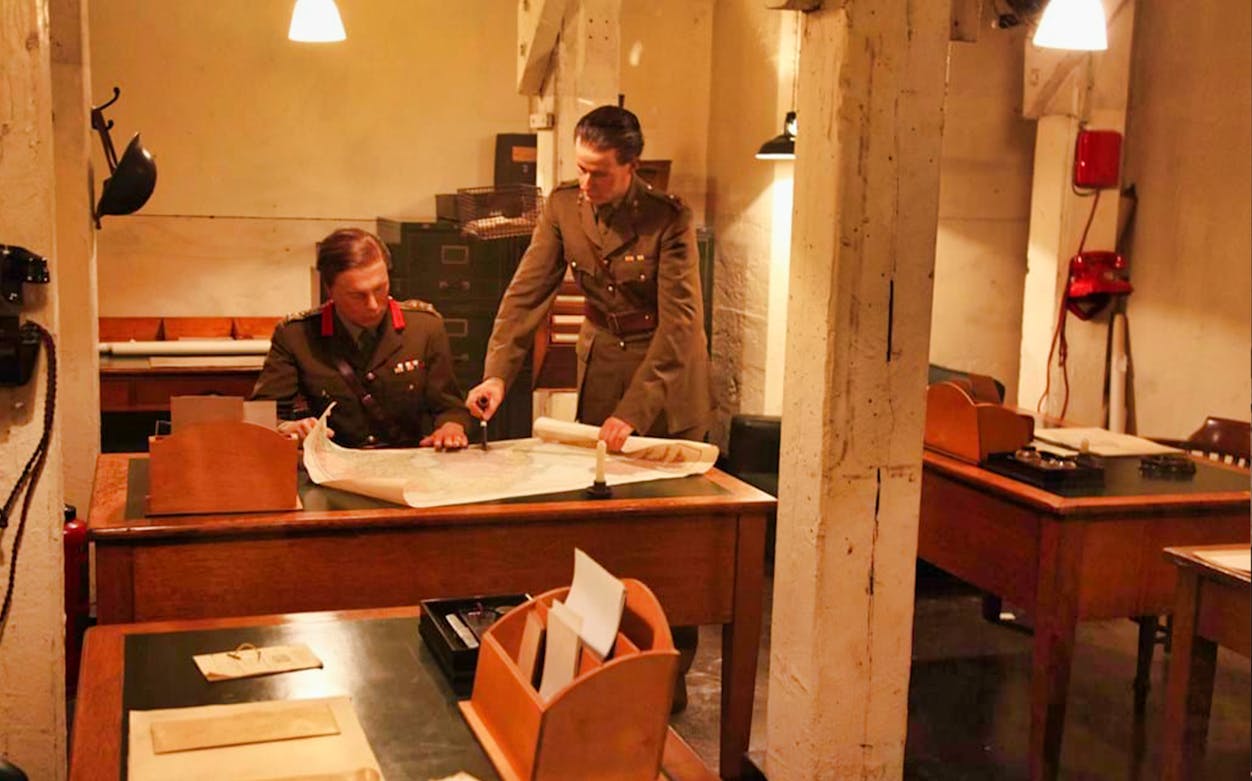 Two men in military uniforms examining a map in Churchill’s War Rooms, London.