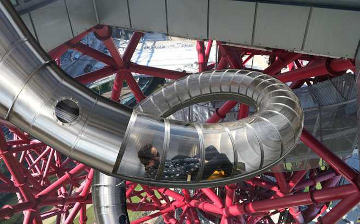 Person sliding down the ArcelorMittal Orbit Slide in London.
