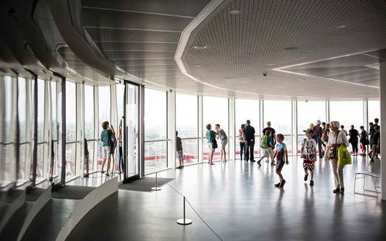 Visitors enjoying skyline views from ArcelorMittal Orbit observation deck in London.