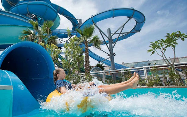 Person enjoying a water slide at Laguna Waterpark.