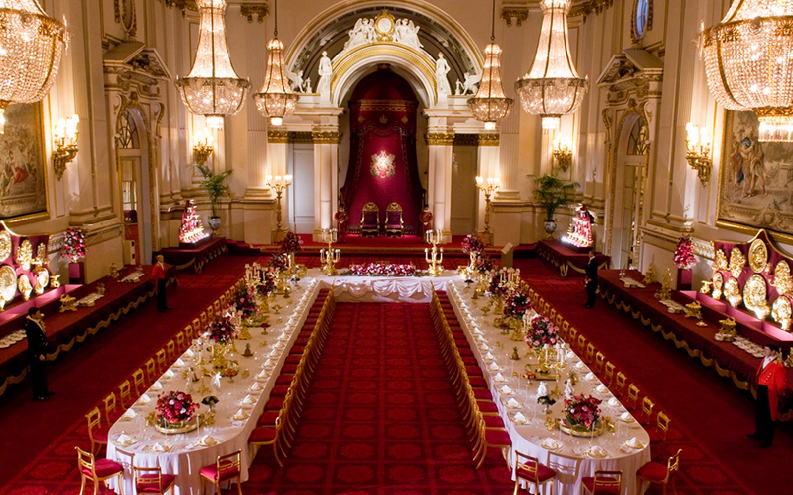 Buckingham Palace State Rooms banquet hall with chandeliers and long dining tables.