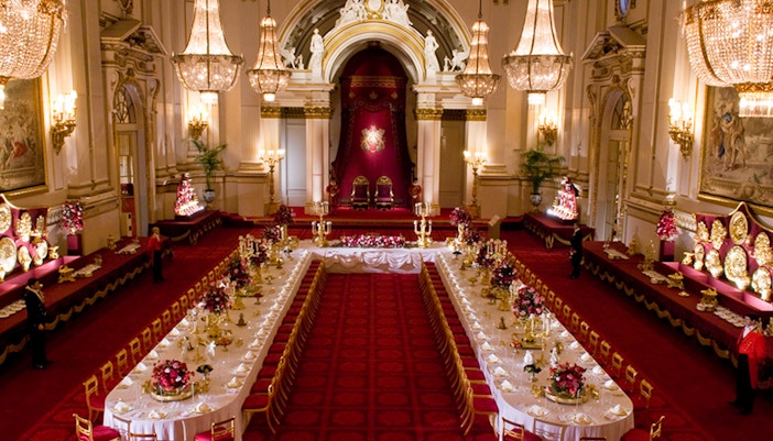 Buckingham Palace State Rooms banquet hall with chandeliers and long dining tables.