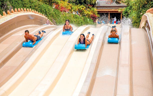 Visitors enjoying water slides at Siam Park, Tenerife.