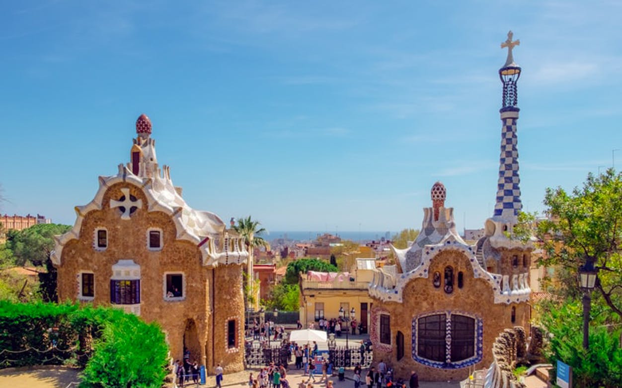 Park Guell entrance with unique architecture and tourists, Barcelona.