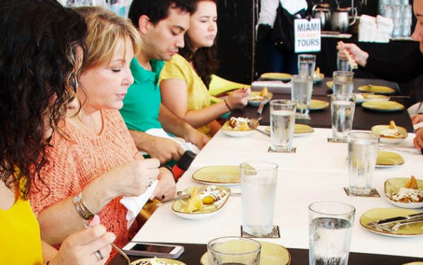 Group enjoying food tasting on Wynwood Food & Art Tour in Miami.