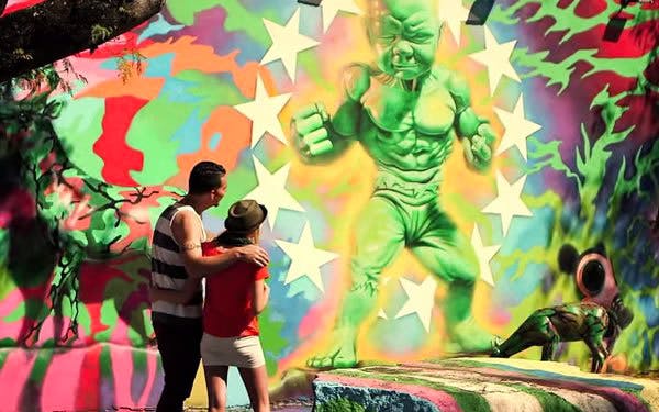 Couple admiring vibrant street art mural in Wynwood, Miami during food and art tour.