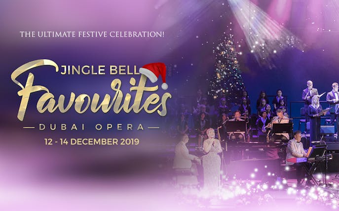 Jingle Bell Favourites concert at Dubai Opera with choir and musicians on stage.