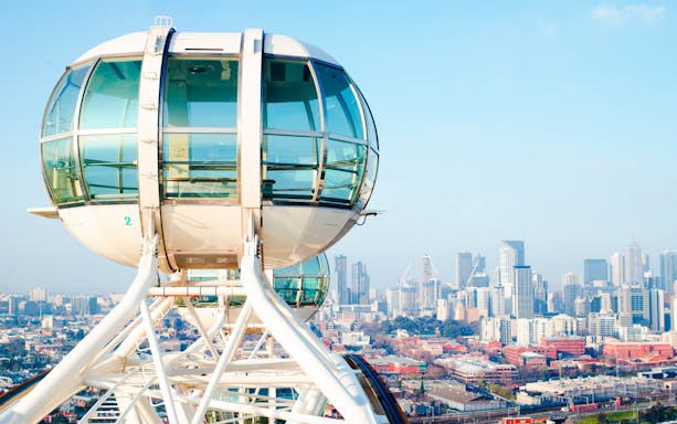 Melbourne Star Observation Wheel cabin with city skyline in the background.