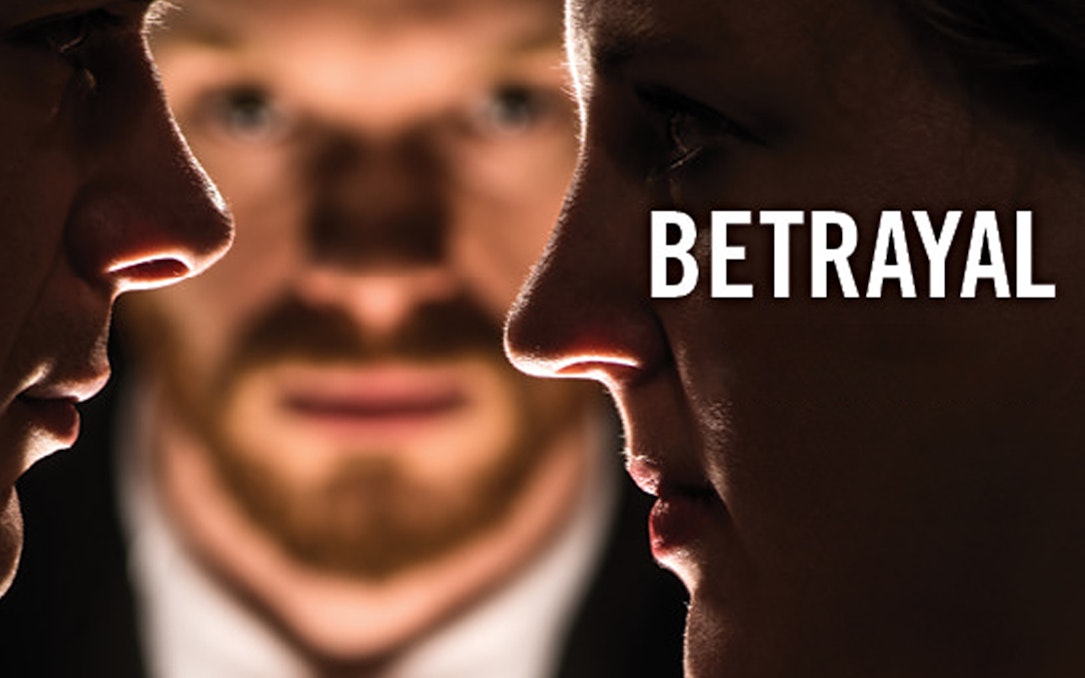 Close-up of two faces with a third person blurred in the background, representing betrayal.