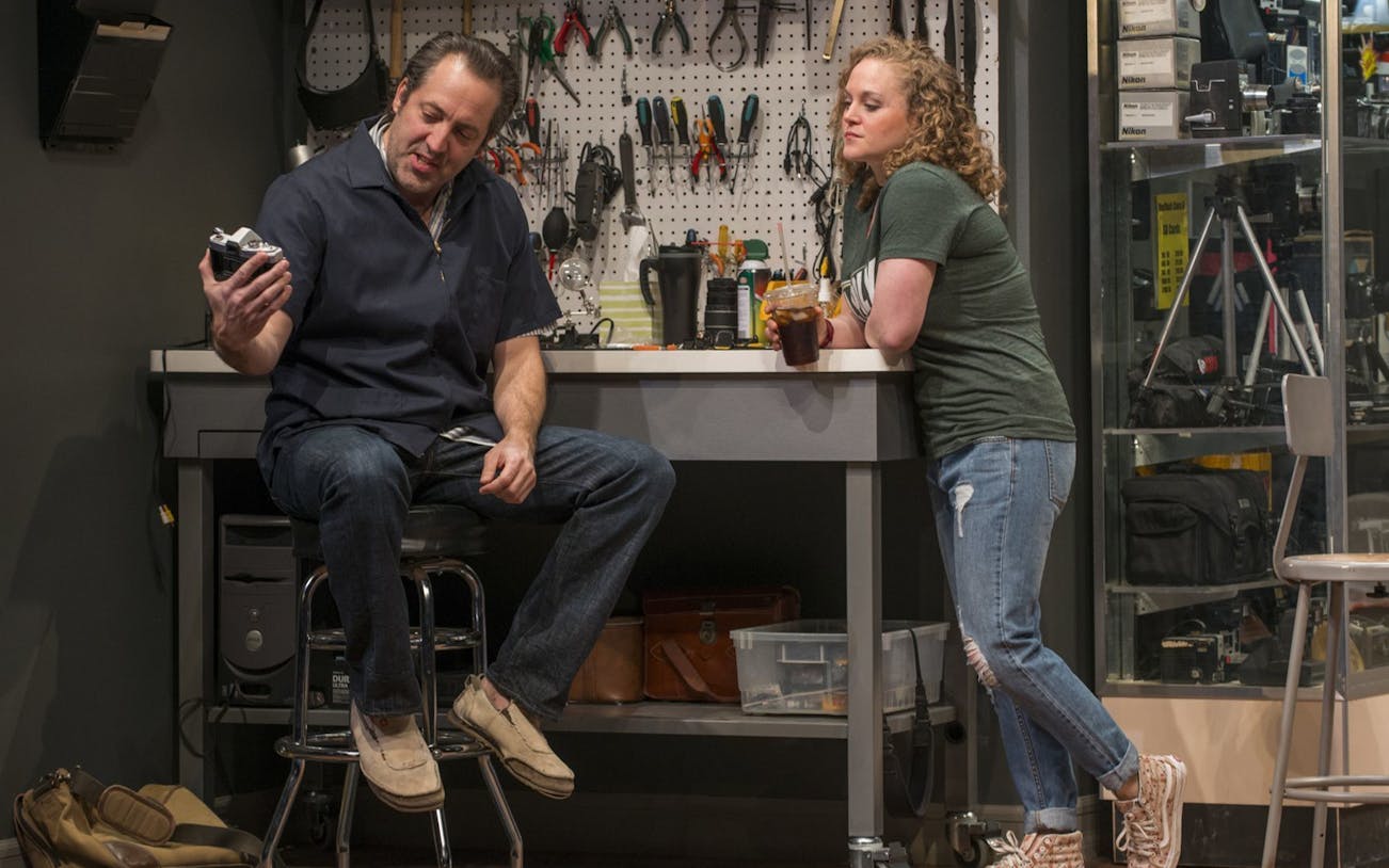 Man and woman in a workshop discussing a camera, Linda Vista.