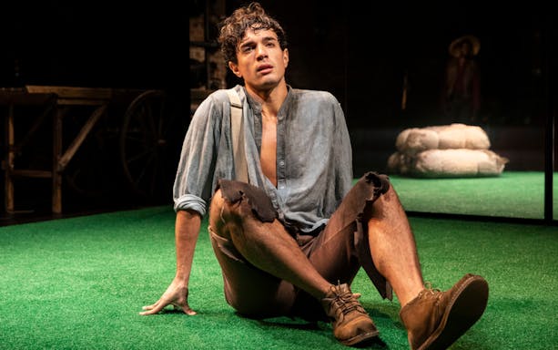 Actor sitting on stage during a performance of "Slave Play.