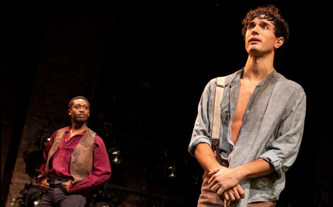 Actors performing a scene from "Slave Play" on stage.