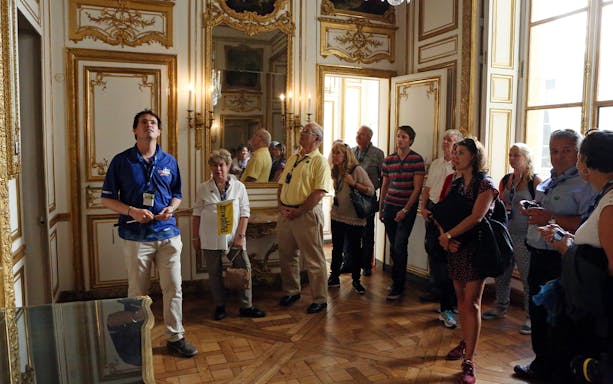 Versailles Palace entrance with tourists on a guided tour, highlighting skip-the-line access.