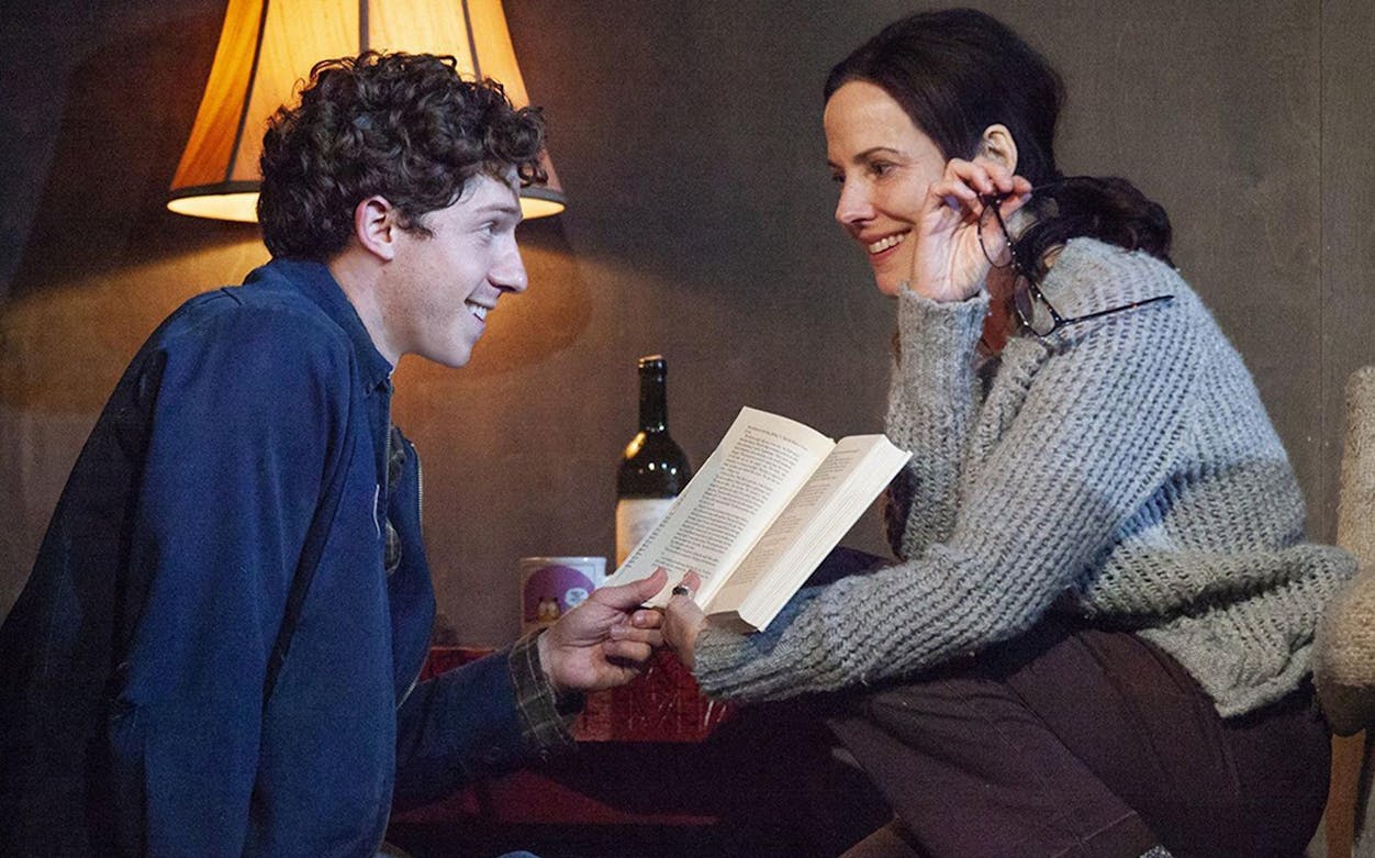 Two people sharing a book in a cozy setting, related to "The Sound Inside.