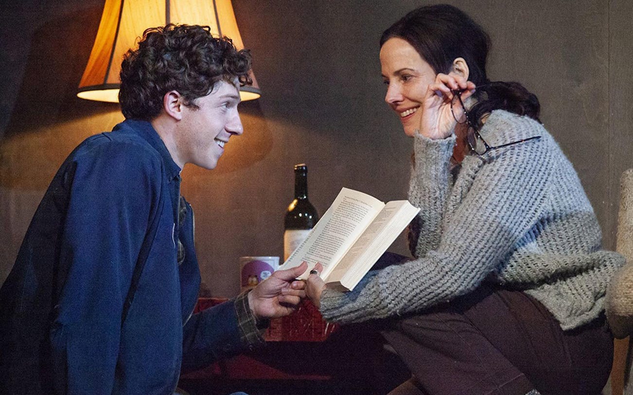 Two people sharing a book in a cozy setting, related to "The Sound Inside.