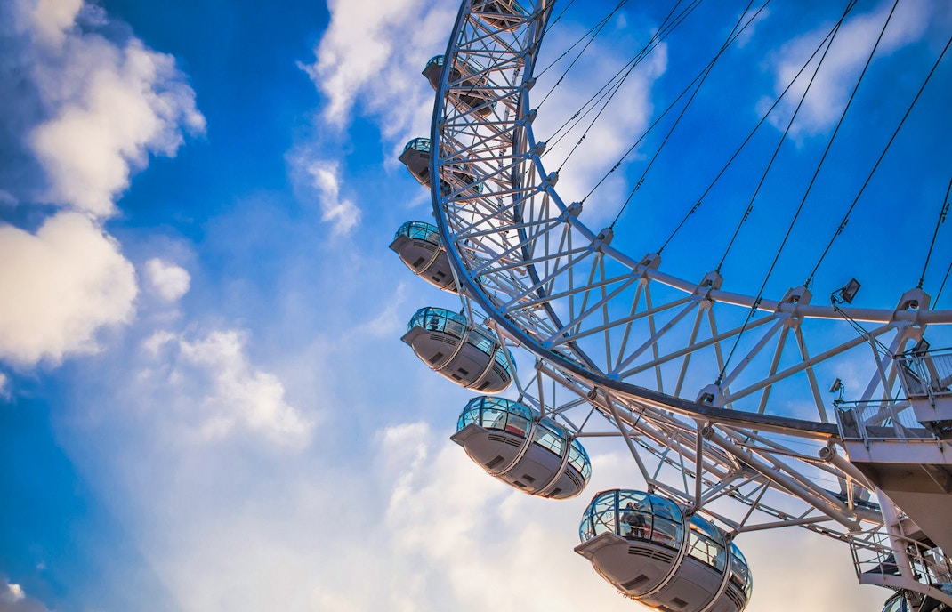 London Eye capsules against a blue sky, part of the river cruise experience.