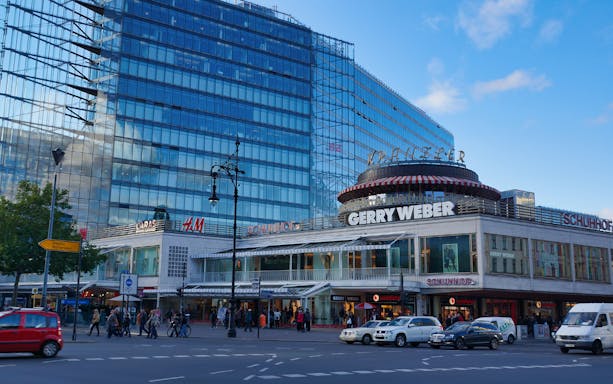 Berlin shopping district with modern glass buildings on Red Bus Hop-On Hop-Off tour route.