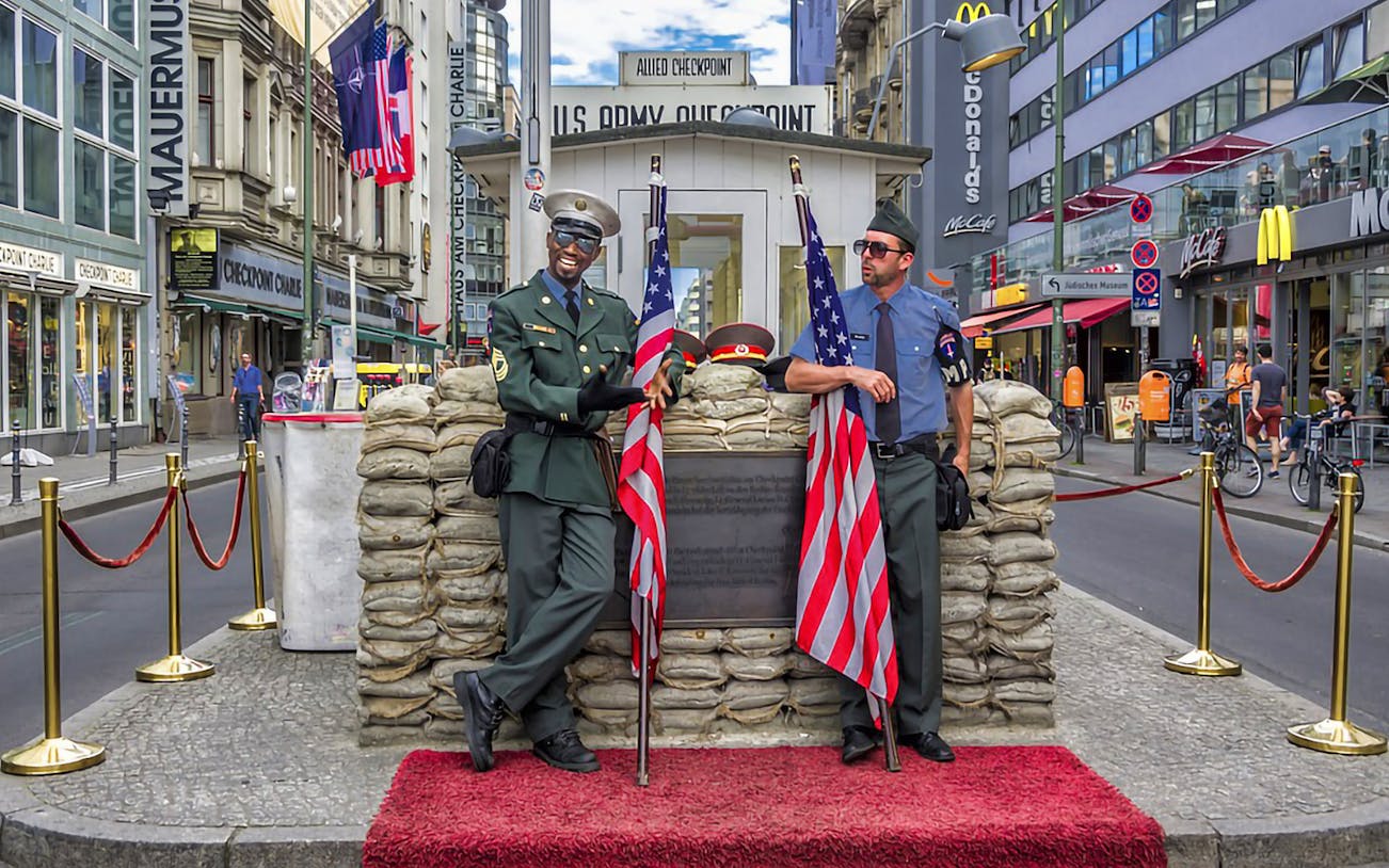 Checkpoint Charlie with actors in military uniforms, part of the Berlin Red Bus Hop-On Hop-Off Tour.