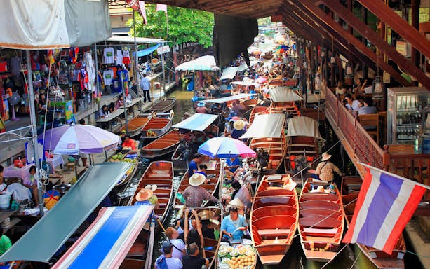 Boats filled with goods and people at Damnoen Saduak Floating Market, Thailand.